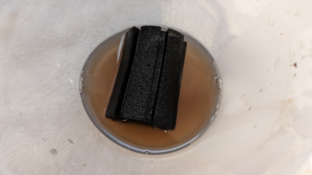 Dirty sponge filter being cleaned