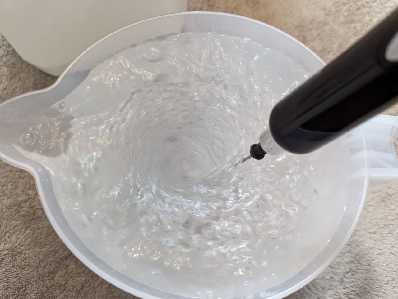 Remineralized water being mixed in a jug for use in a shrimp tank